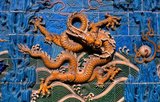 The Nine Dragon Screen, dating back to 1417, is an 87-foot wall decorated with glazed tiles showing nine dragons chasing a pearl in clouds above waves.